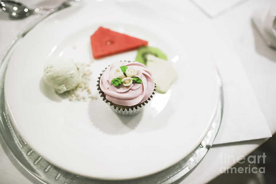 Desserts and wedding cake with very sweet cupcakes at an event. #1 Photograph by Joaquin Corbalan