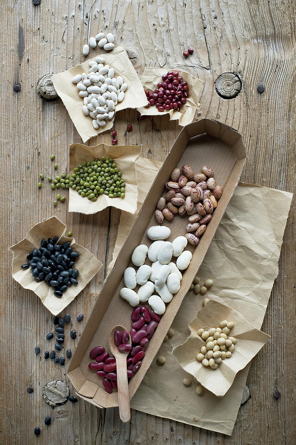 Different Types Of Beans On A Rustic Wooden Table #1 Photograph by Achim Sass
