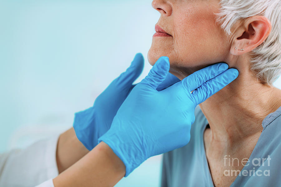 Doctor Examining A Senior Womans Neck #1 Photograph by Microgen Images/science Photo Library