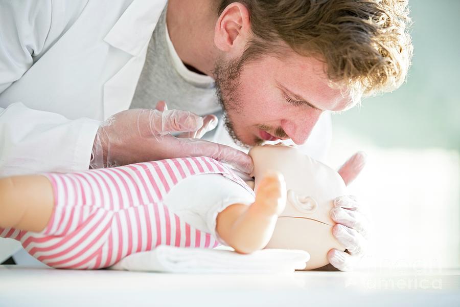 First Aid Photograph - Doctor Practising Infant Cpr #1 by Science Photo Library