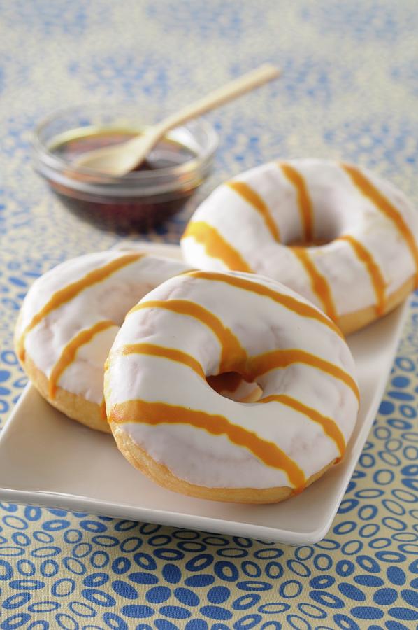 Doughnuts With White Glaze And Caramel Sauce #1 Photograph by Jean-christophe Riou