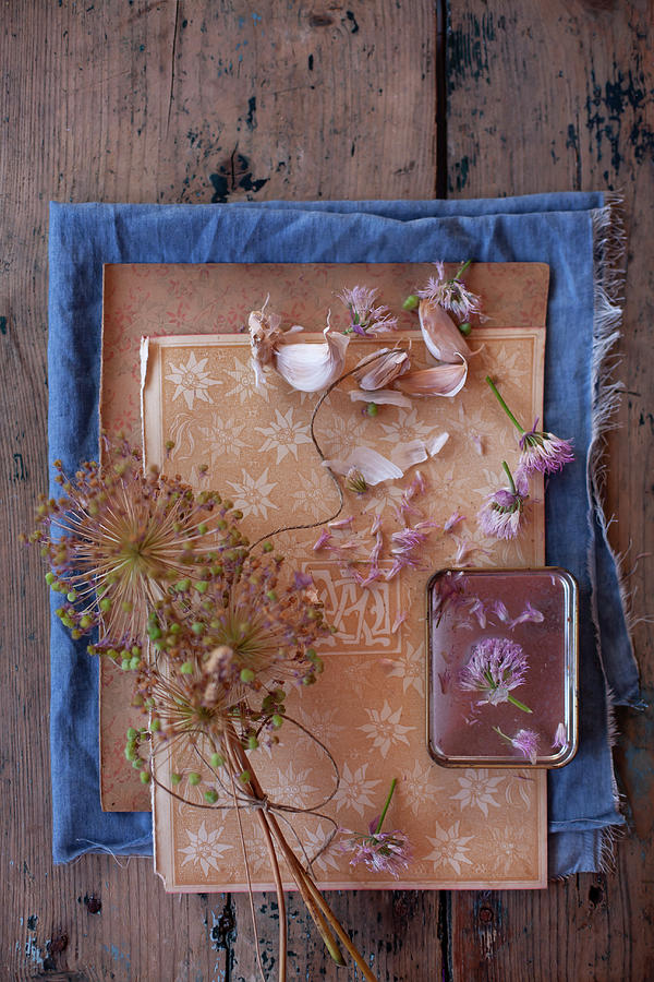 Dried Garlic Flowers Tied Together And Garlic Bulbs Decorating Table #1 Photograph by Alicja Koll
