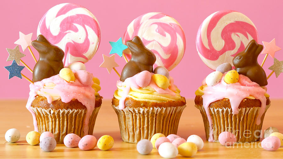 Easter theme candy land drip cupcakes in party table setting. #1 Photograph by Milleflore Images