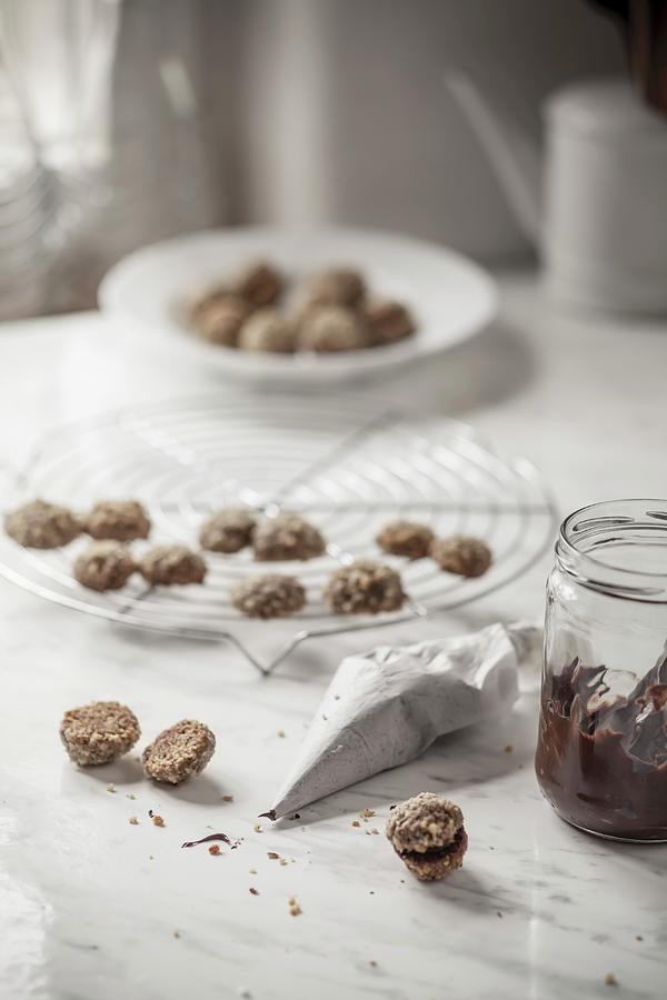 Espresso And Walnut Cookies Being Filled With Nut Nougat Cream #1 Photograph by Susan Brooks-dammann