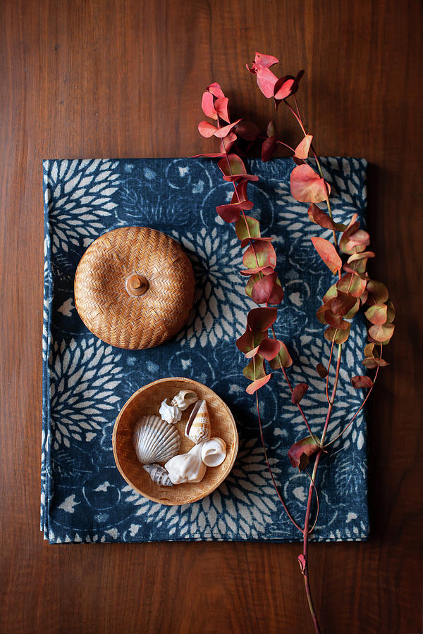 Eucalyptus Sprig In Autumn Colours And Seashells In Basket On Blue Fabric #1 Photograph by Alicja Koll