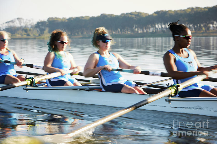 Female Rowers Rowing Scull On Sunny Lake Photograph by Caia Image