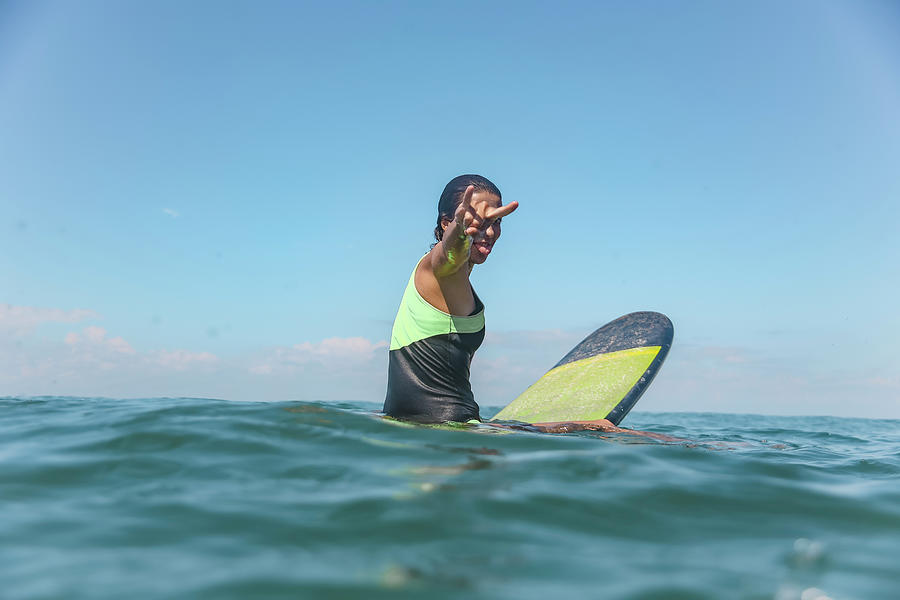 Female Surfer Sitting On Surfboard #1 Photograph By Cavan Images - Pixels