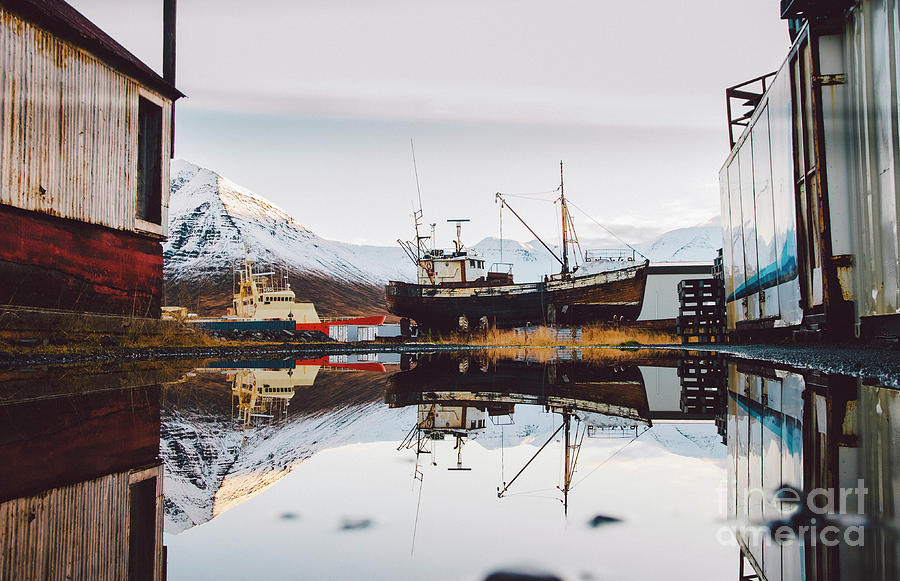 Fishing port of the village of Seydisfjordur, in Iceland, with vibrant colors and reflections in the sea of fishing boats. #1 Photograph by Joaquin Corbalan