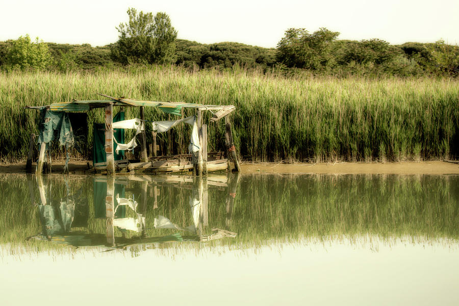 Fishing shack on sea channel Photograph by Vivida Photo PC
