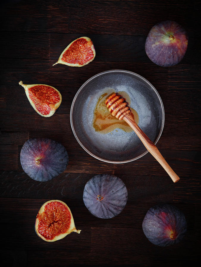 Fresh Figs And A Honey Dipper On A Dark Wooden Background #1 Photograph by Dominik Paunetto