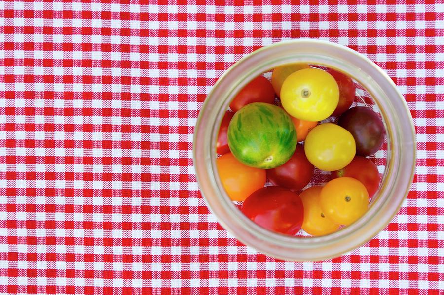 Fresh Heirloom Tomatoes In A Preserving Jar On A Checked Tablecloth #1 Photograph by Veronesi, Larissa