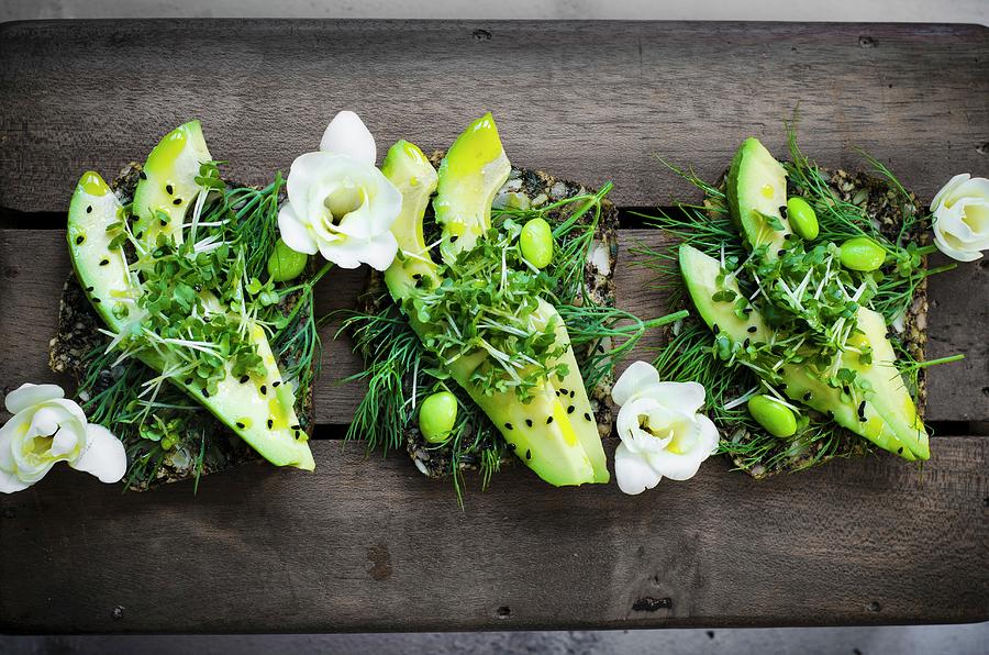 Fresh Slices Of Avaocado On Seeded Bread With Avaocado Oil, Endemame Beans And Micro Greens #1 Photograph by Donna Crous
