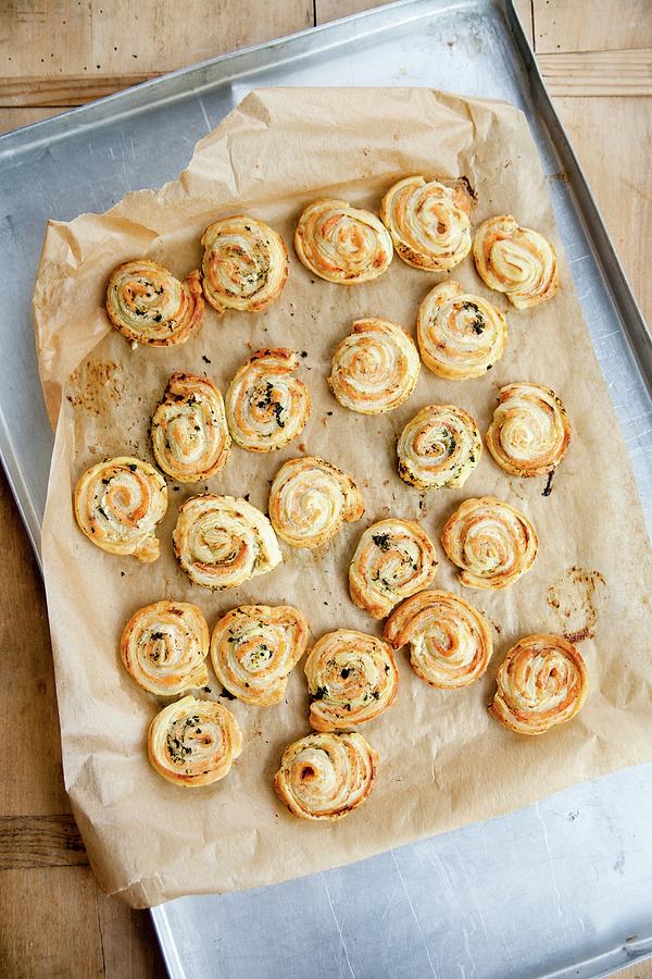 Freshly Baked Salmon Puff Pastry Swirls On A Baking Sheet #1 Photograph by Claudia Timmann