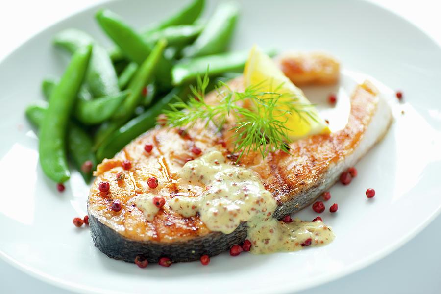 Fried Salmon Steak With Sugar Snap Peas, Honey And Mustard Sauce And Red Peppercorns #1 Photograph by Foodografix