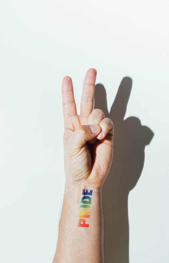 Gay Photograph - Gay Guys Hand With A Tattoo That Says Pride And Nail Polish. by Cavan Images
