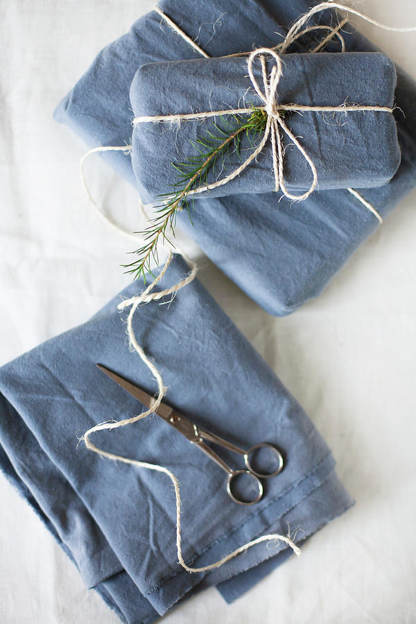 Gifts Wrapped In Blue Fabric Tied With Parcel String #1 Photograph by Alicja Koll