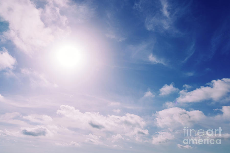 Glowing sun in a blue summer sky with nice white clouds. #1 Photograph by Joaquin Corbalan