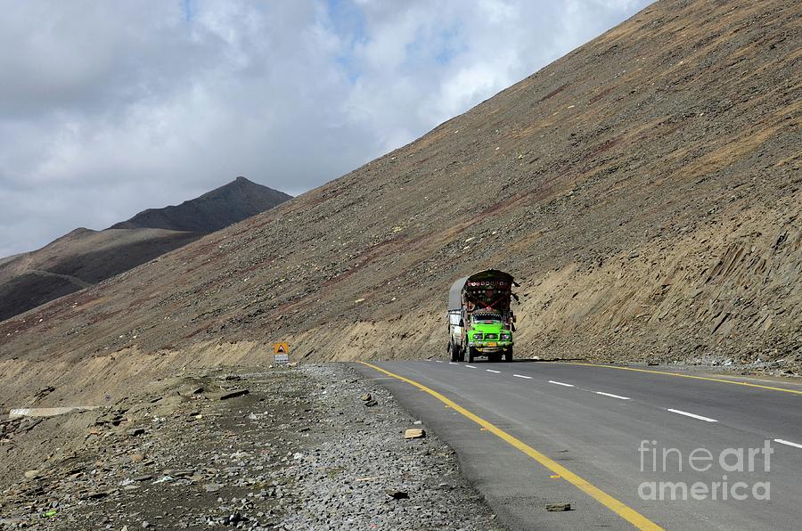 Mountain Photograph - Green goods truck on Karakoram Highway amid mountains Babusar Pass Pakistan #2 by Imran Ahmed