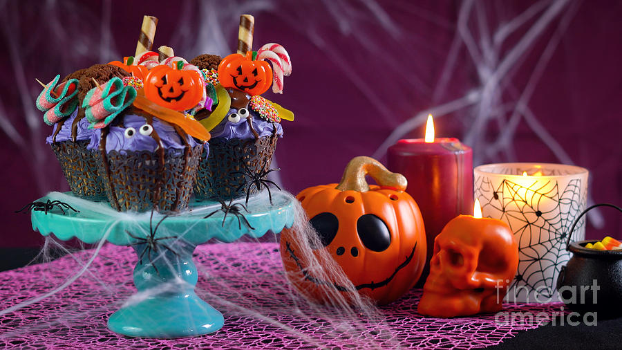 Halloween candyland drip cake style cupcakes in party table setting. #1 Photograph by Milleflore Images