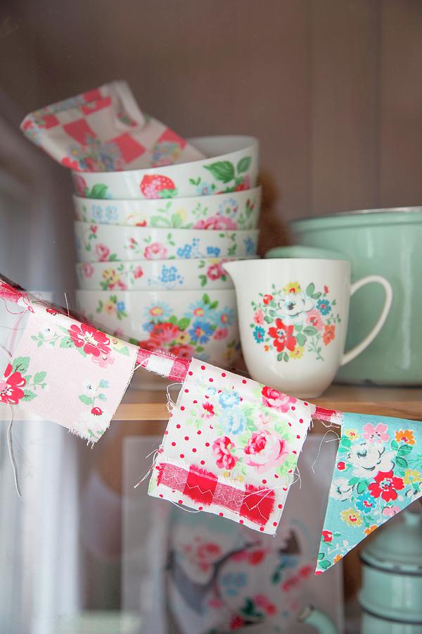 Hand-sewn Bunting And Floral Crockery On Shelves Of Kitchen Dresser #1 Photograph by Syl Loves