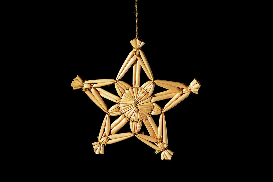 A straw star hanging on a christmas tree Photograph by Stefan Rotter -  Pixels