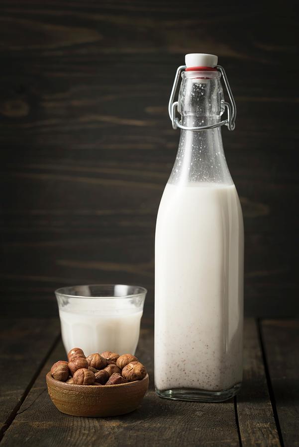 Hazelnut Milk In A Glass Bottle #1 Photograph by Elisabeth Clfen
