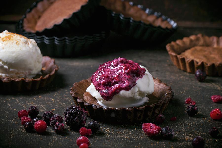 Homemade Ice Cream With Frozen Berries In Chocolate Tartlet Bases #1 Photograph by Natasha Breen