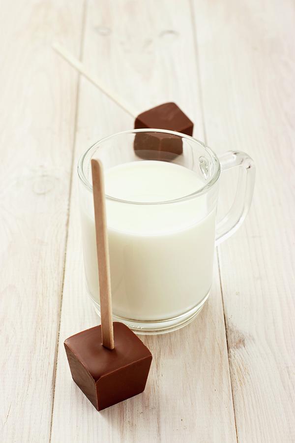 Hot Milk And A Cube Of Chocolate To Dip In It #1 Photograph by Petr Gross