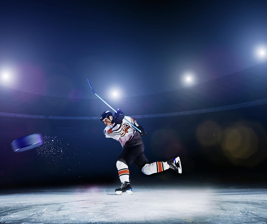 Ice Hockey Player Shooting Puck Photograph by Robert Decelis Ltd