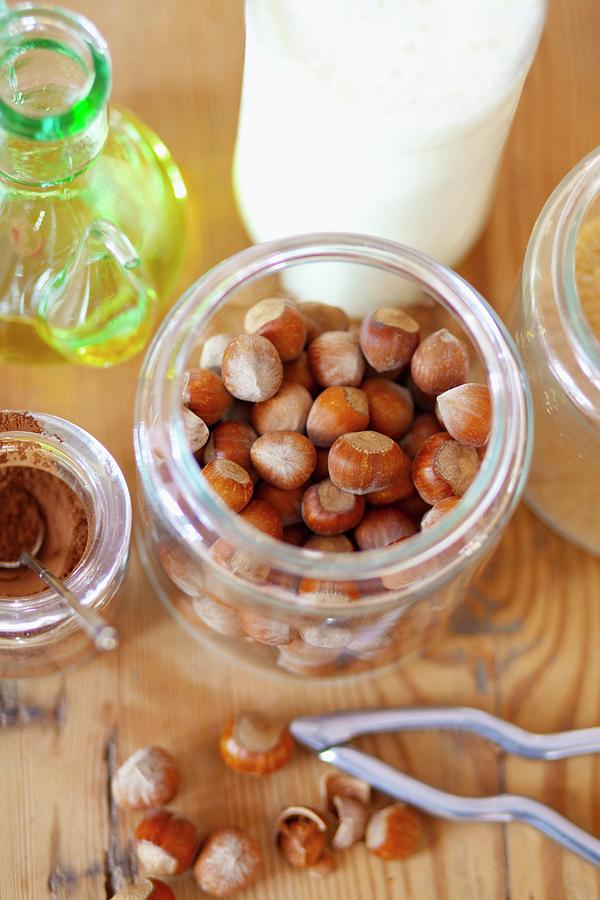 Ingredients For Chocolate & Hazelnut Spread: Hazelnuts, Olive Oil, Cocoa Powder, Brown Sugar And Milk #1 Photograph by Studio Lipov
