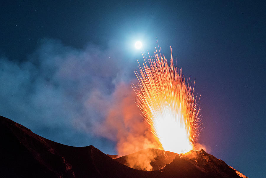 Italy, Sicily, Messina District, Aeolian Islands, Stromboli, Volcano In Eruption With Stars And Moon At Night #1 Digital Art by Manfred Bortoli