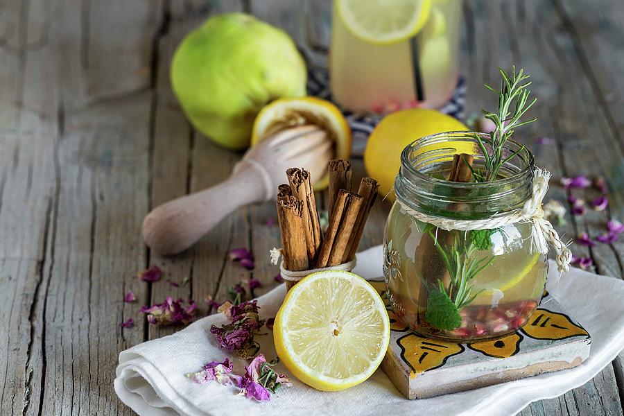 Lemonade With Fresh Lemon, Mint, Cinnamon And Quince On A Wooden Surface #1 Photograph by Eduardo Lopez Coronado