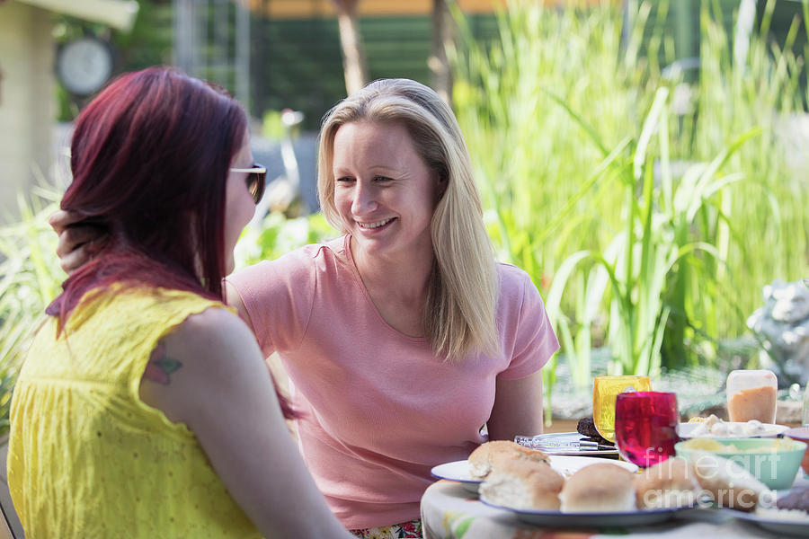 Lesbian Couple Enjoying Lunch On Patio Photograph By Caia Imagescience