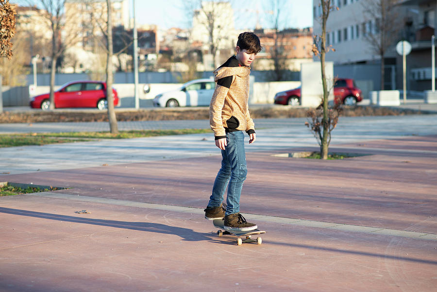 Cool Photograph - Male Skateboarder Riding And Practicing Skateboard In City Outdoors #1 by Cavan Images