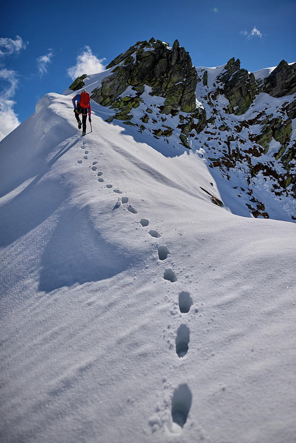 Man Climbing A Snowy Mountain On A Sunny Day In Devero, Italy ...