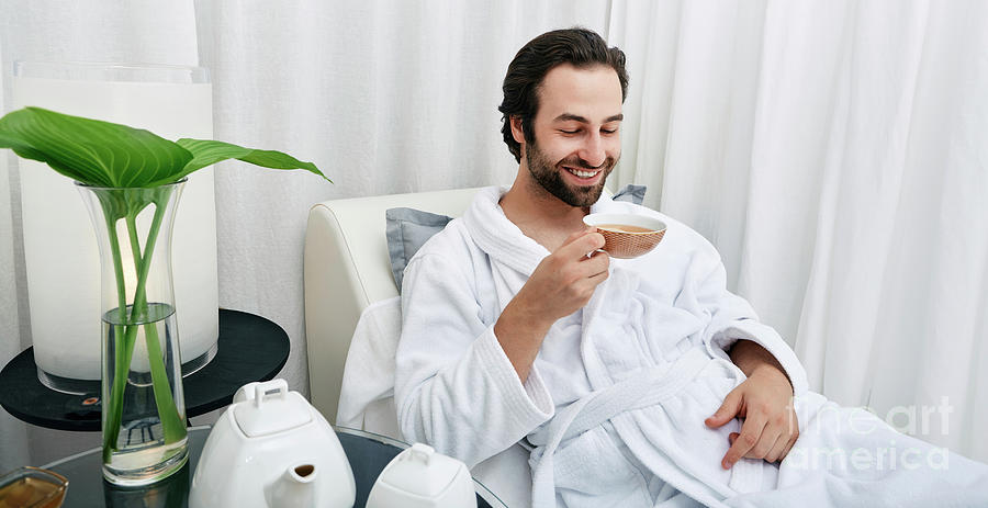 Man Drinking Tea At A Spa #1 Photograph by Peakstock / Science Photo Library