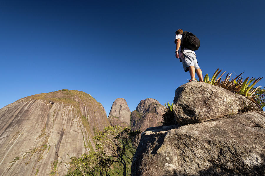 Jungle Photograph - Man Posing Near Dramatic Rocky Mountain Peaks On The Rainforest #1 by Cavan Images