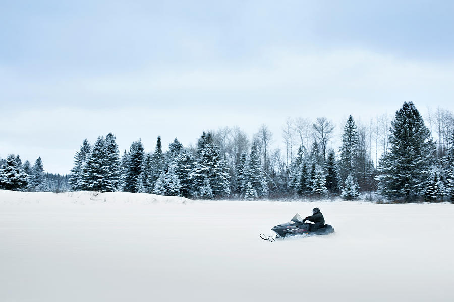 Man Riding Snowmobile On Landscape Against Sky #1 Photograph by Cavan Images
