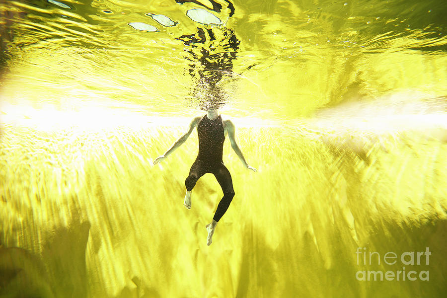 Man Swimming Underwater On Yellow #1 Photograph by Stanislaw Pytel