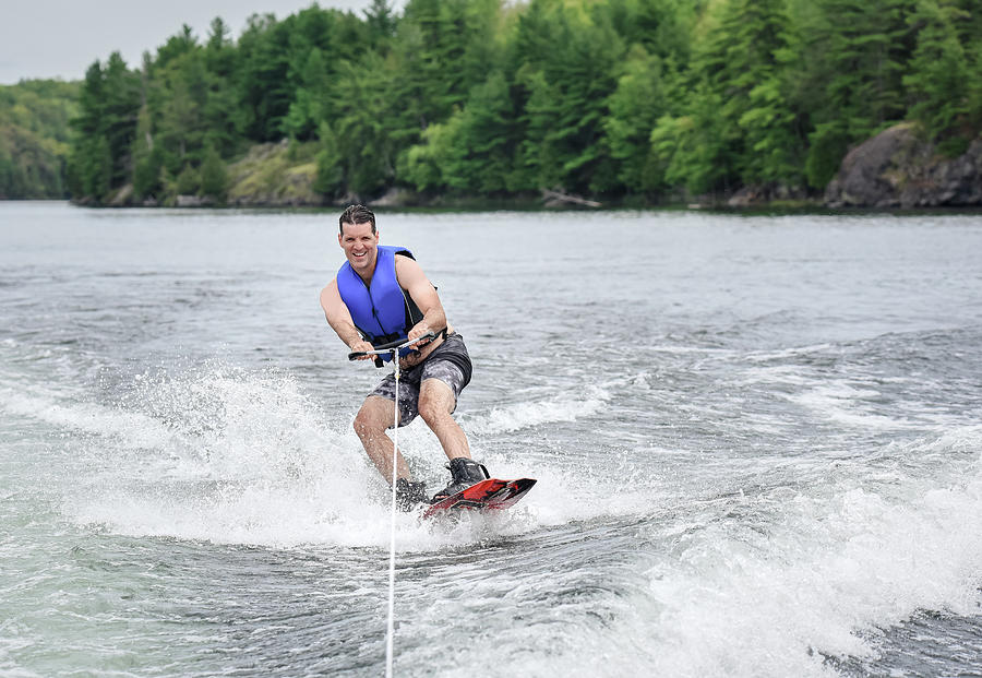 Man Wake Boarding While Being Pulled By A Boat On A Lake. Photograph by ...