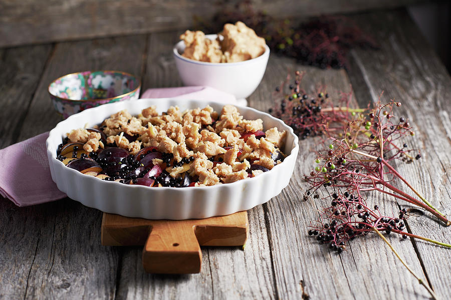Marzipan Crumble With Prunes And Elderberries #1 Photograph by Hannah Kompanik