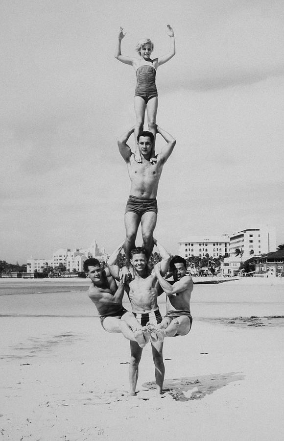 Men And Girl Perform Acrobatics On Beach Photograph by Archive Holdings Inc. Men And Girl Perform Acrobatics On Beach Photograph by Archive Holdings Inc.