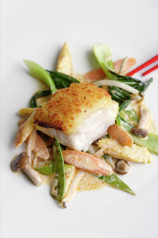 Monk Fish With A Ginger Crust On A Bed Of Stir-fried Vegetables With Coconut Milk #1 Photograph by Michael Wissing