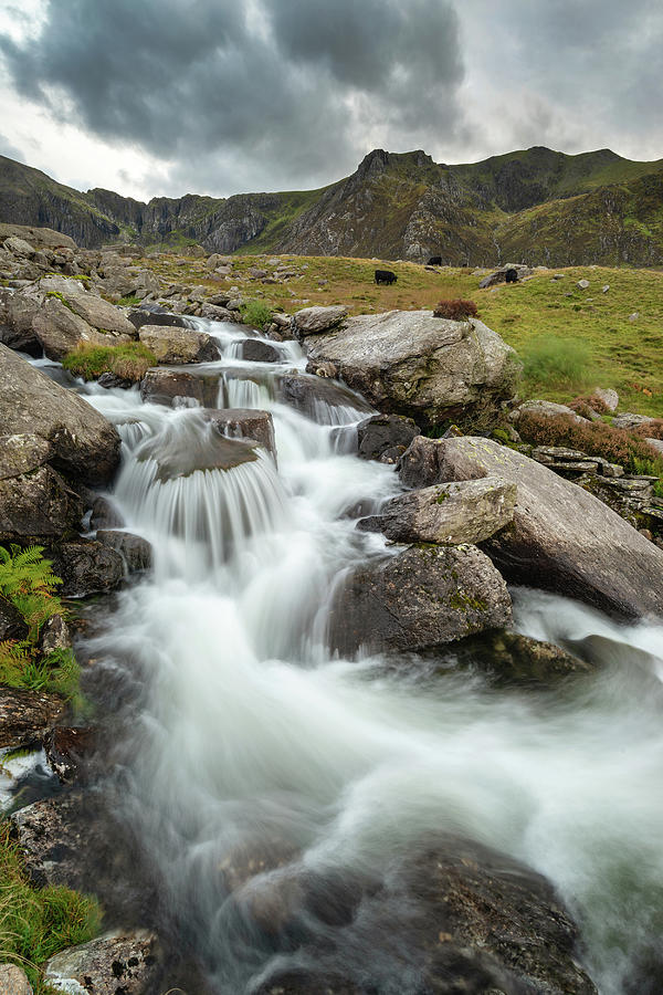 Moody Landscape Image Of River Flowing Down Mountain Range Near 