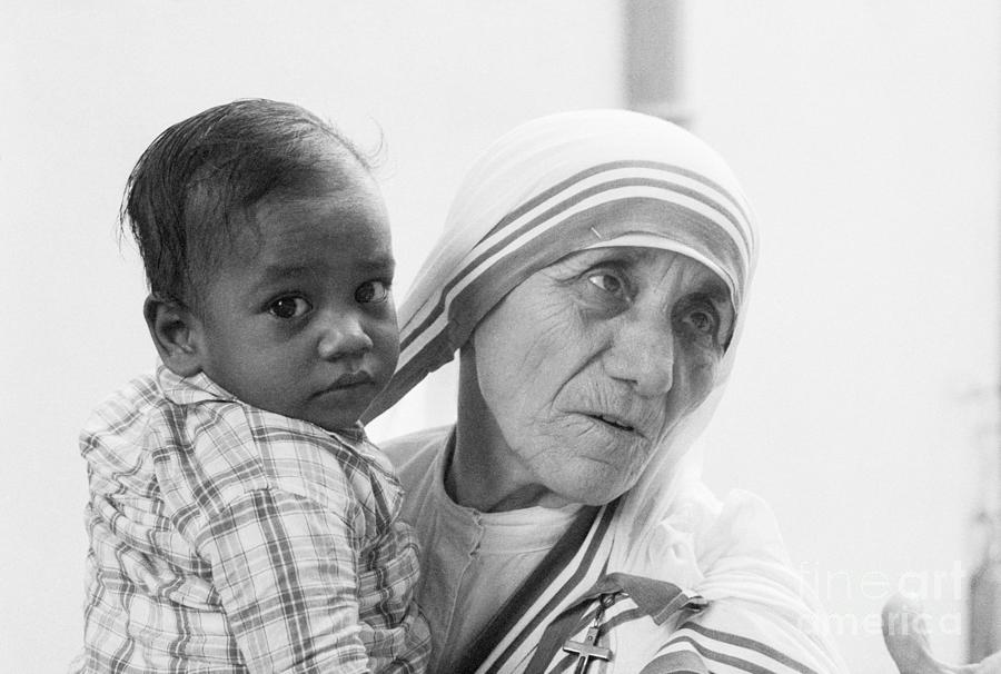 Mother Teresa Holding Young Boy #1 Photograph by Bettmann