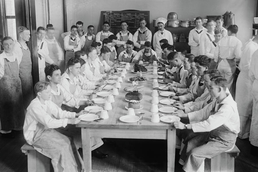 Naval Cadets sit at long table with bowls in front Painting by Unknown ...