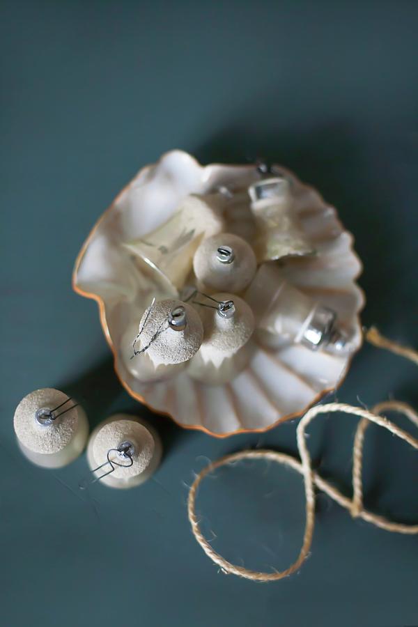 Old Christmas-tree Baubles In Scallop Shell #1 Photograph by Alicja Koll