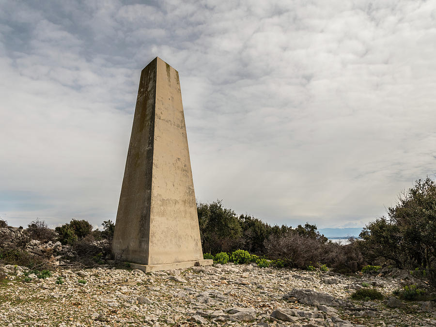 Old concrete triangular pillar on the island of Cres Photograph by