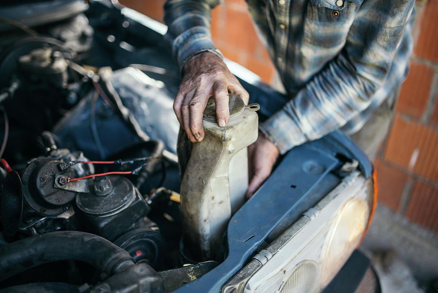 Old Man Working On Vintage Car In His Garage At Home. Photograph by ...