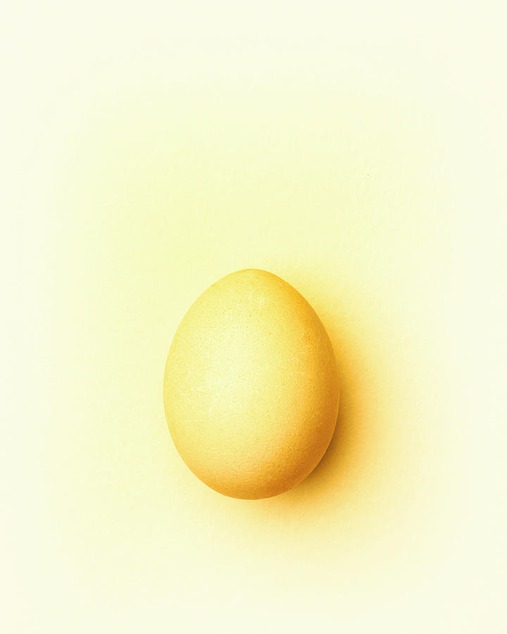 Pale Yellow Easter Egg On A Pale Yellow Background #1 Photograph by Peter Rees